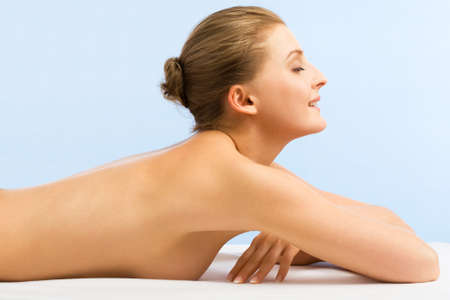 Beautiful woman in spa center on blue backgroundの写真素材