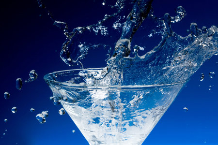 Sparks of blue water on a blue backgroundの写真素材