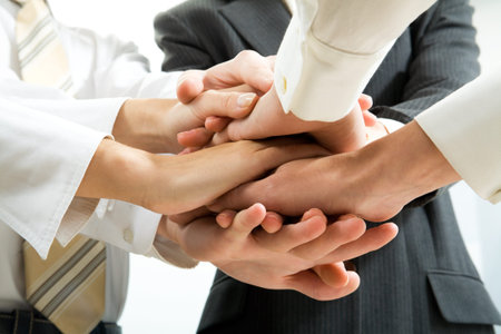 Business people hands on top of each other 
