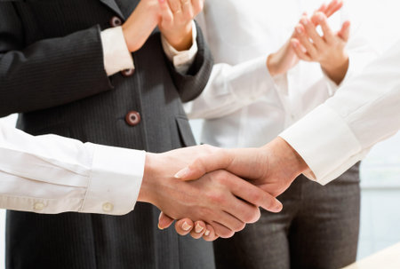 Shaking hands of two business people 