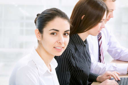 Portrait of successful businesswoman and business team at office meetingの写真素材