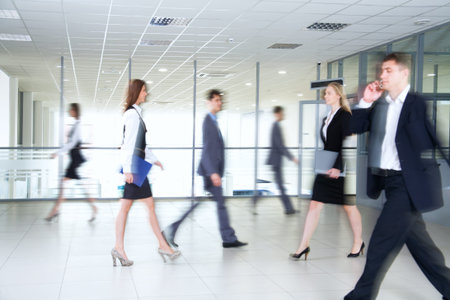 Business people walking in the office corridorの写真素材