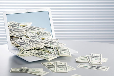 Earning money over the internet. Dollars running out of computer 