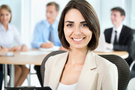 Successful business woman sitting with her team at office