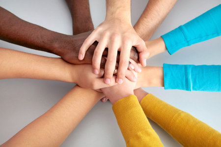 High view of team of friends showing unity with their hands together