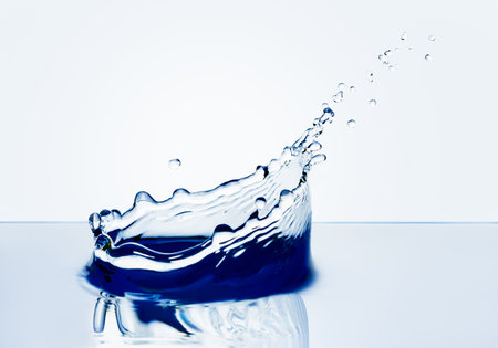 Beautiful splash of water falling from a slice of lemon