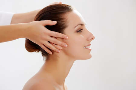 Masseur doing massage on woman face in the spa salon. Beauty treatment concept.の写真素材