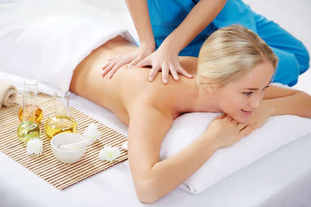 Healthy life. Young beautiful woman relaxed in spa environmentの写真素材