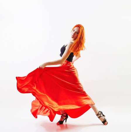 Woman traditional dancer wearing red dress isolated on grey backgroundの写真素材