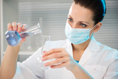 Attractive young female scientist working in laboratory