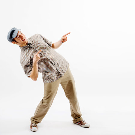 Funny man standing while presenting against white background