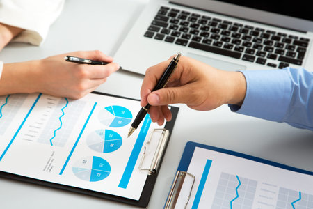 Close-up of businessman explaining a financial plan to colleagues at meeting