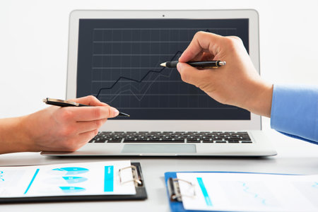 Close-up of businesswoman explaining a financial plan to colleague