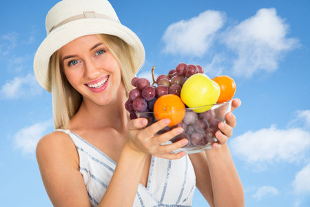 Smiling pretty woman with fruitsの写真素材