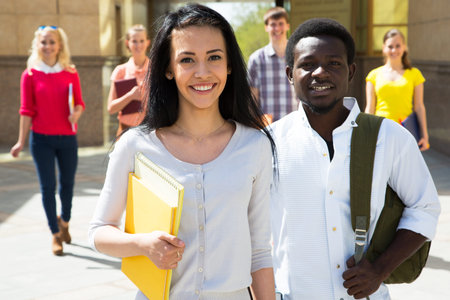 Group of diverse students outside smiling togetherの写真素材