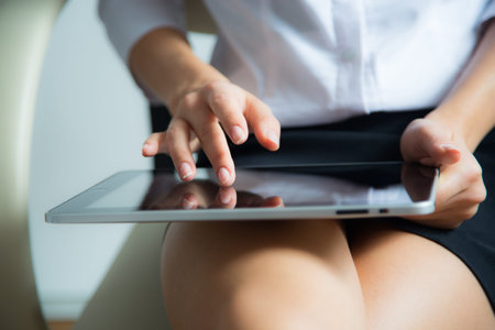 Woman using a tablet computer. Close up.