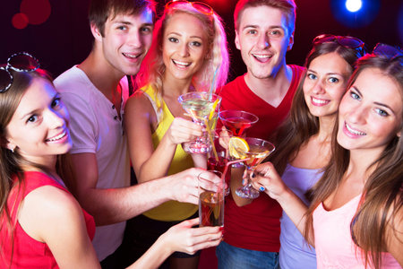 Happy people clinking by glasses with each other