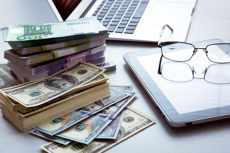 The workplace of business people. Laptop and money.の写真素材