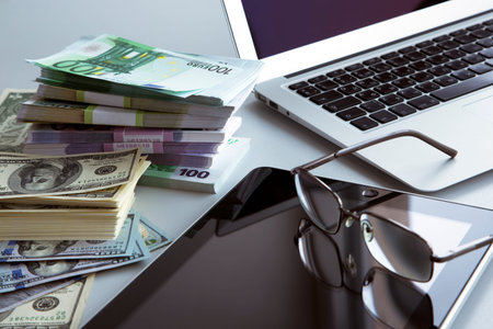 The workplace of business people. Laptop and money.の写真素材