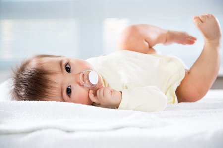 Happy baby lying on a towel