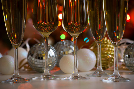 Glasses of champagne and christmas balls on the background