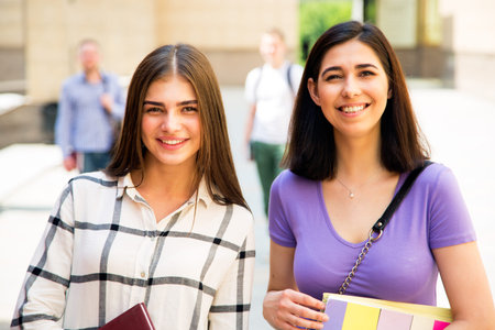 Female students outdoors with her friendsの写真素材