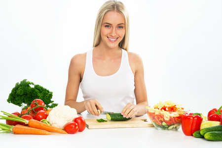 Young woman cooking  vegetable saladの写真素材