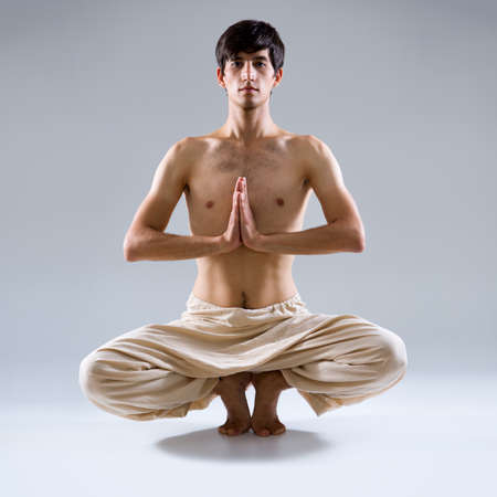 Young man doing yogaの写真素材