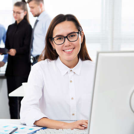 Businesswoman working with computer in an officeの写真素材