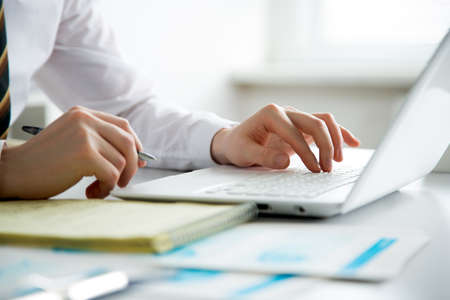 Close-up of hands of business man typing on a laptop.の写真素材