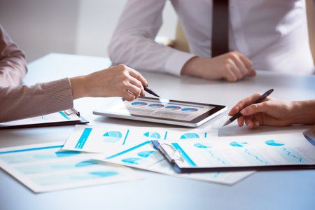 Business people working with tablet computer in an office. Close-up