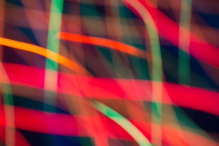 Abstract picture of bright colored dynamic lights on a dark backgroundの写真素材