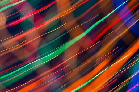 Abstract picture of bright colored dynamic lights on a dark backgroundの写真素材