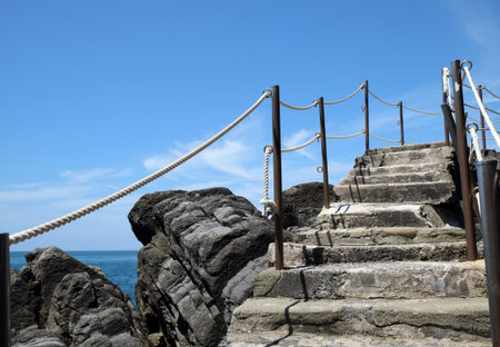 Beautiful landscape with an ancient staircase amidst stones by the seaの写真素材