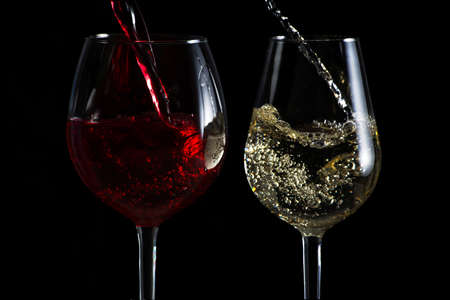 Beautiful splash of wine in a glass on a black backgroundの写真素材