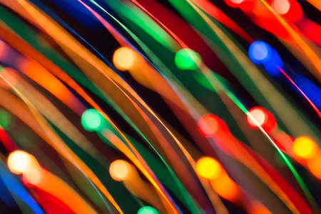 Abstract picture of bright colored dynamic lights on a dark backgroundの写真素材