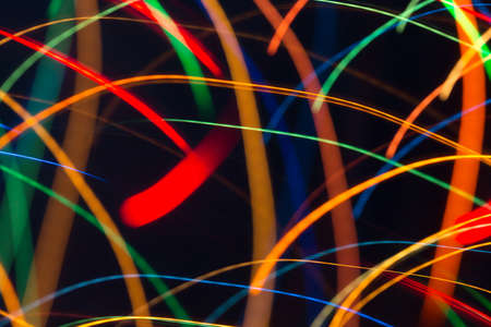 Abstract picture of bright colored dynamic lights on a dark backgroundの写真素材