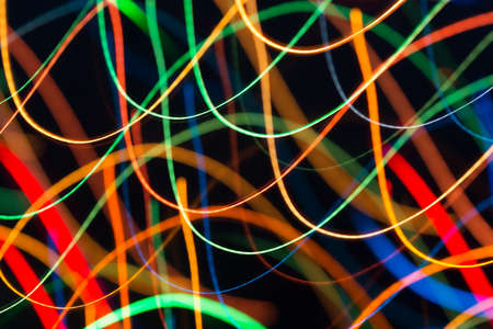 Abstract picture of bright colored dynamic lights on a dark backgroundの写真素材