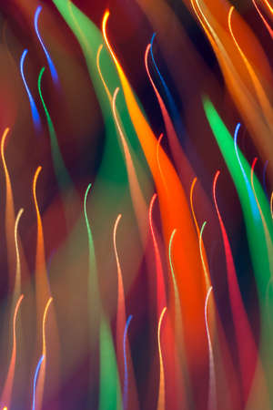 Abstract picture of bright colored dynamic lights on a dark backgroundの写真素材