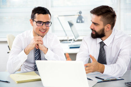 Young businessmen discussing new project at meetingの写真素材