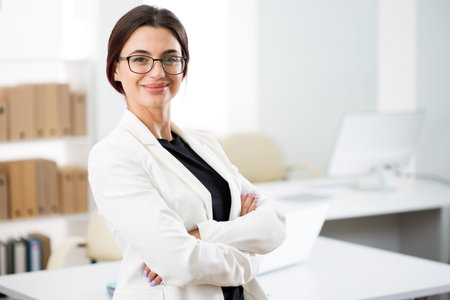 Portrait of a smiling young attractive business woman in an office