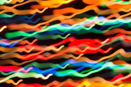 Abstract picture of bright colored dynamic lights on a dark backgroundの写真素材