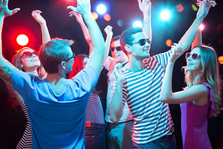 Group of happy young people having fun dancing at party.の写真素材