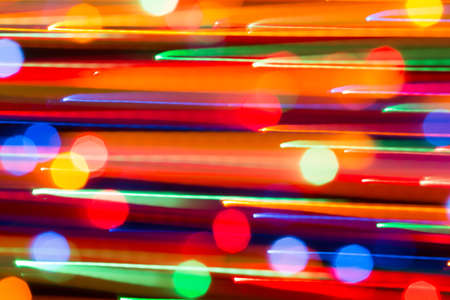 Abstract picture of bright colored dynamic lights on a dark backgroundの写真素材