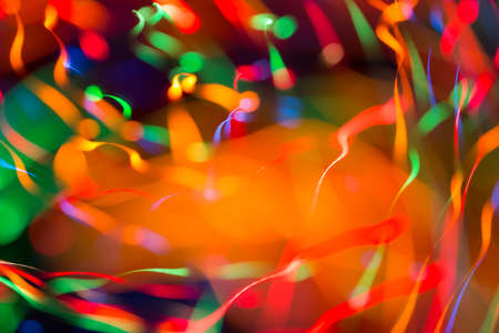 Abstract picture of bright colored dynamic lights on a dark backgroundの写真素材