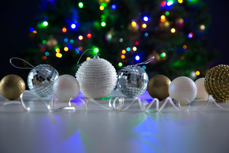 Christmas balls against the backdrop of a festive Christmas tree. Blue background
