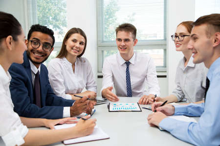 Businessman explains to colleagues a new project in the modern officeの写真素材