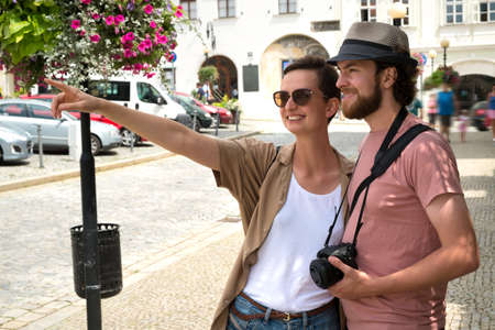 Happy young couple walking in the city on a tourist trip.の写真素材
