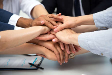 International business team showing unity with their hands togetherの写真素材