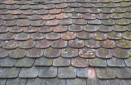 Beautiful background of old shabby roof tiles in the old town